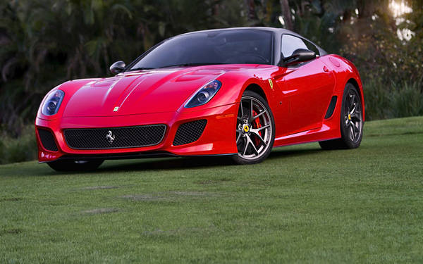 This jpeg image - Red Ferrari on Green Grass Wallpaper, is available for free download