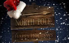 North Pole Sign with Santa Hat Christmas Background