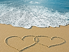 Romantic Sea Background with Hearts in the Sand