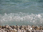 Waves and White Beach Pebbles Background