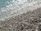 White Beach Pebbles and Waves Background